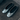 A pair of metallic silver flat shoes with black bow details on the toes, displayed on a dark textured fabric surface.